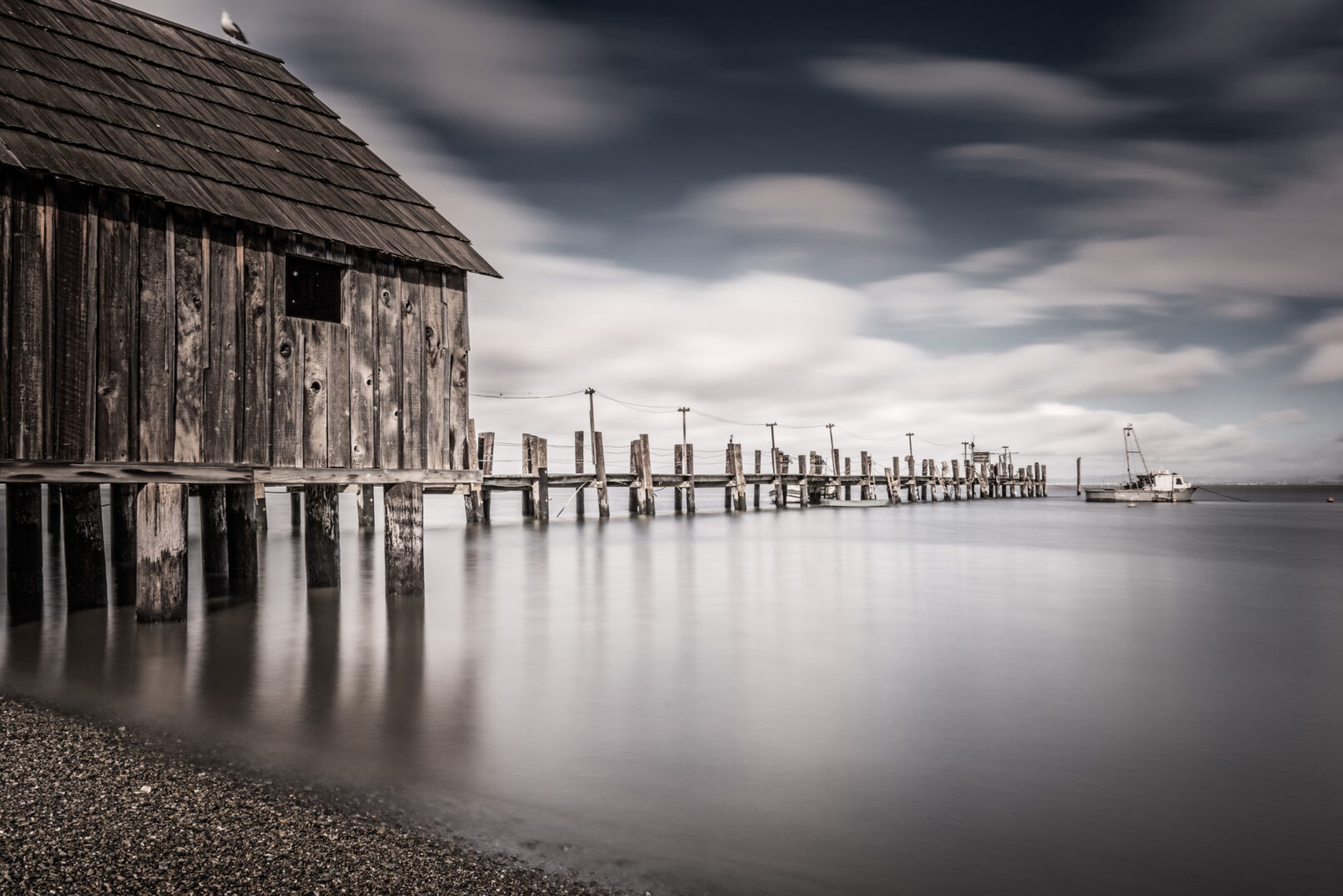 Pier with streaked clouds, San Pablo Bay, China Camp Park, California