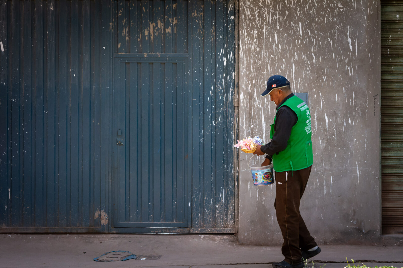 Peruvian man holding bucket