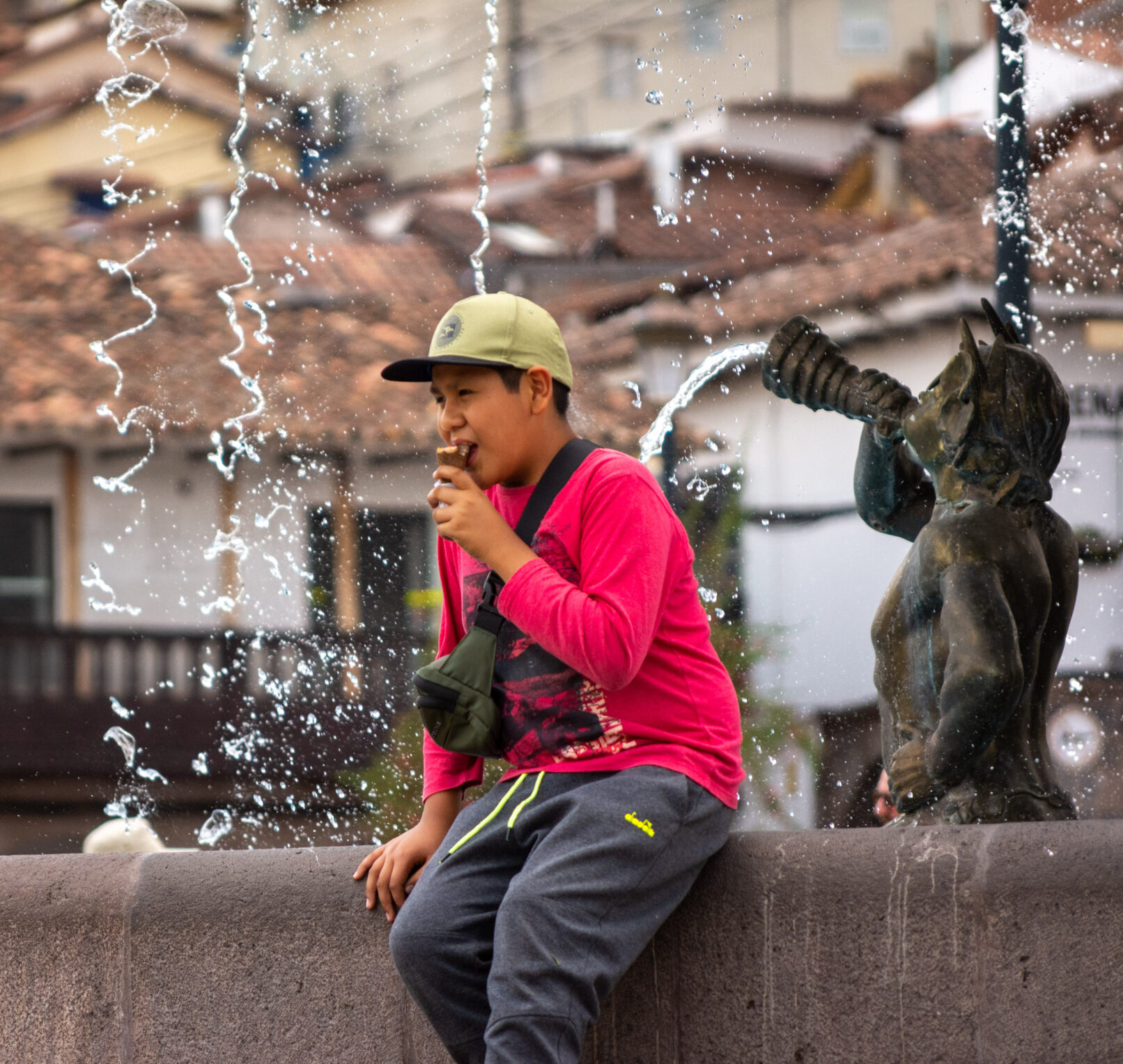 Boy on fountain in Cusco, Peru