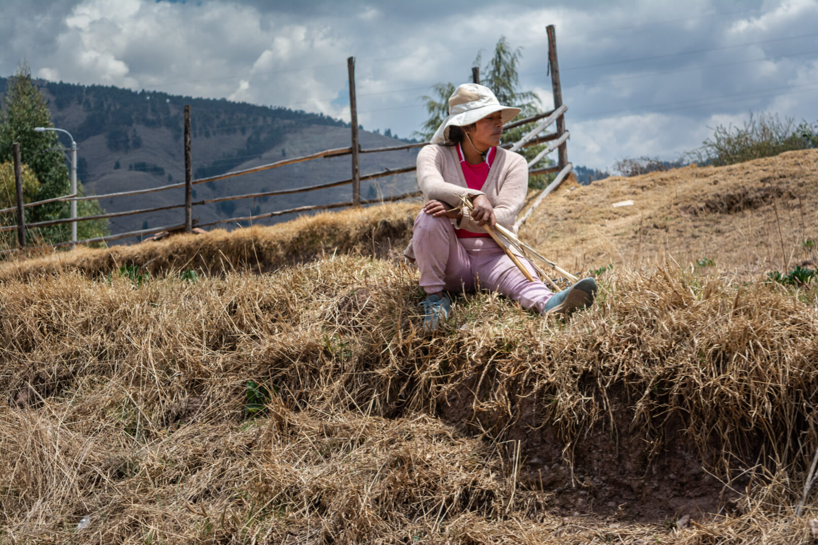 Woman sitting in hay