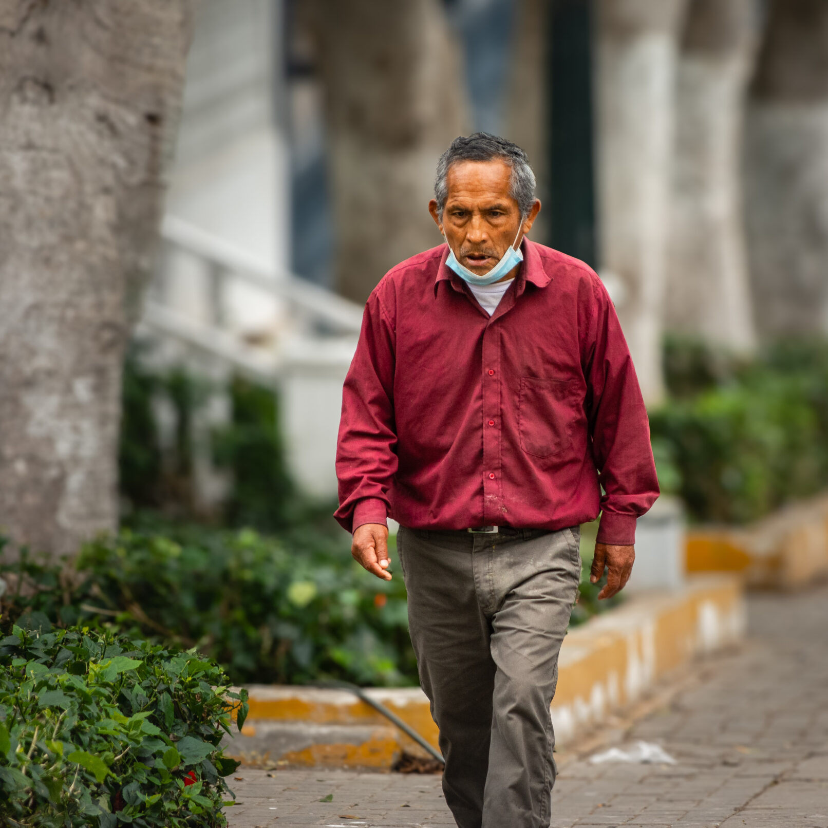 Peruvian man walking down street