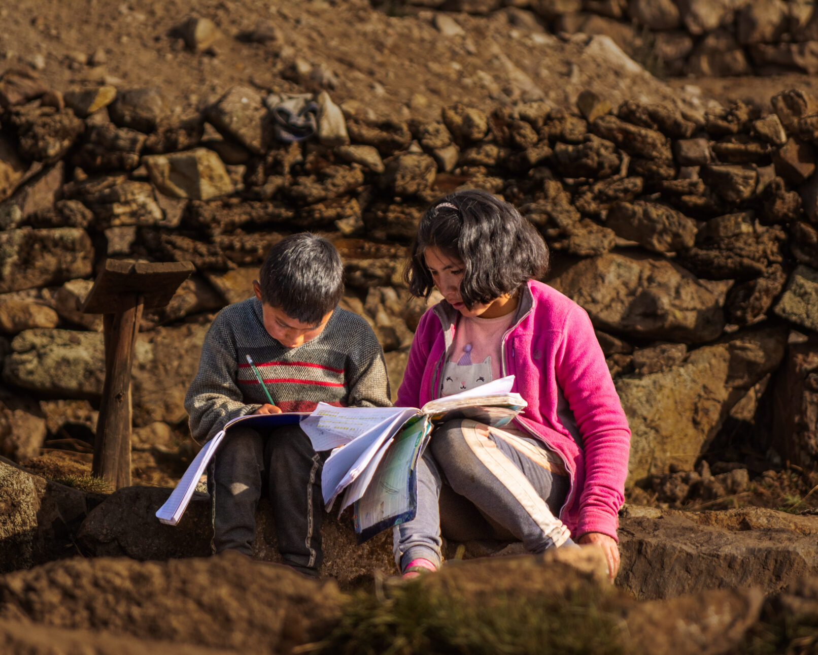 Peruvian village boy and girl studying