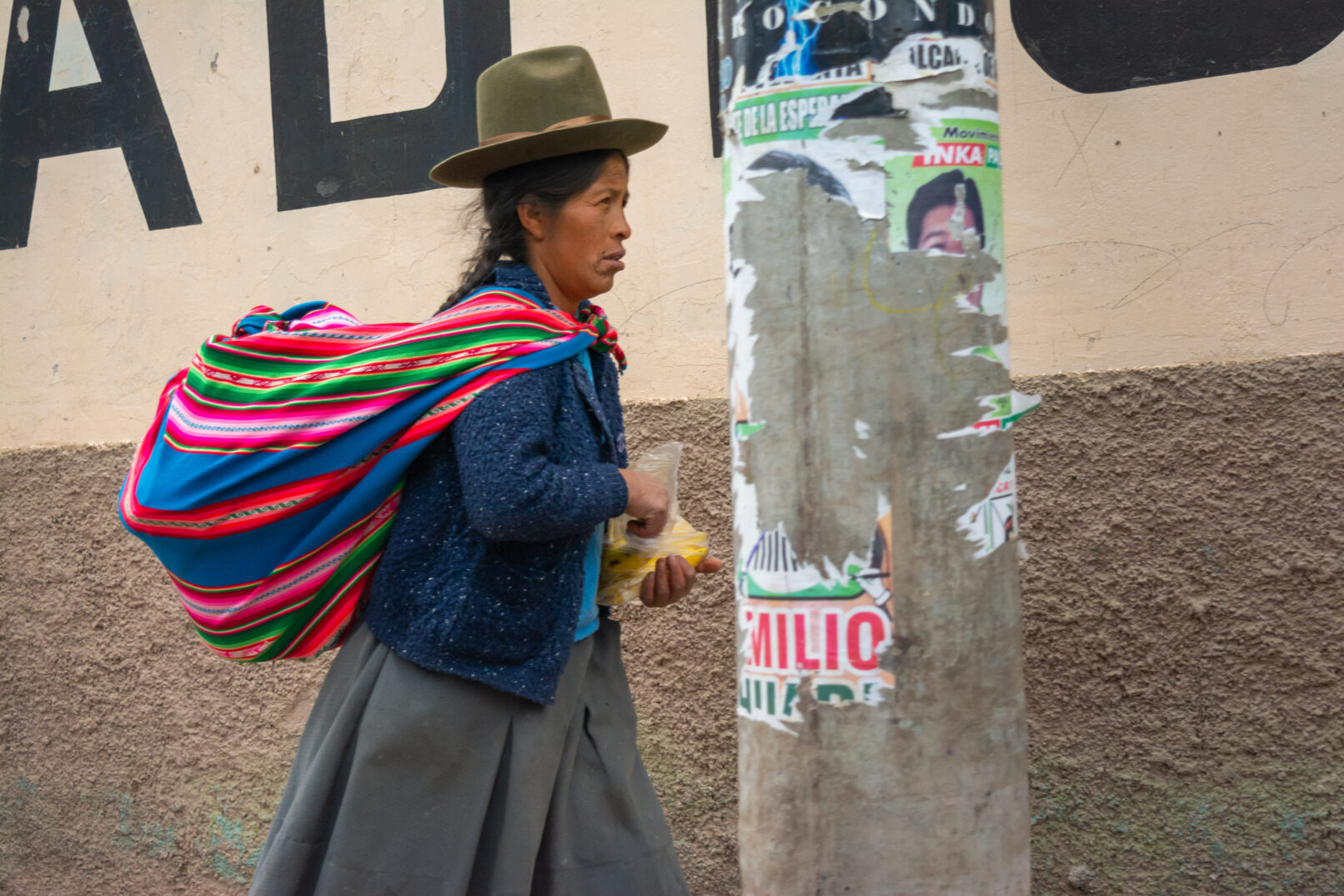 Peruvian woman walking on street.