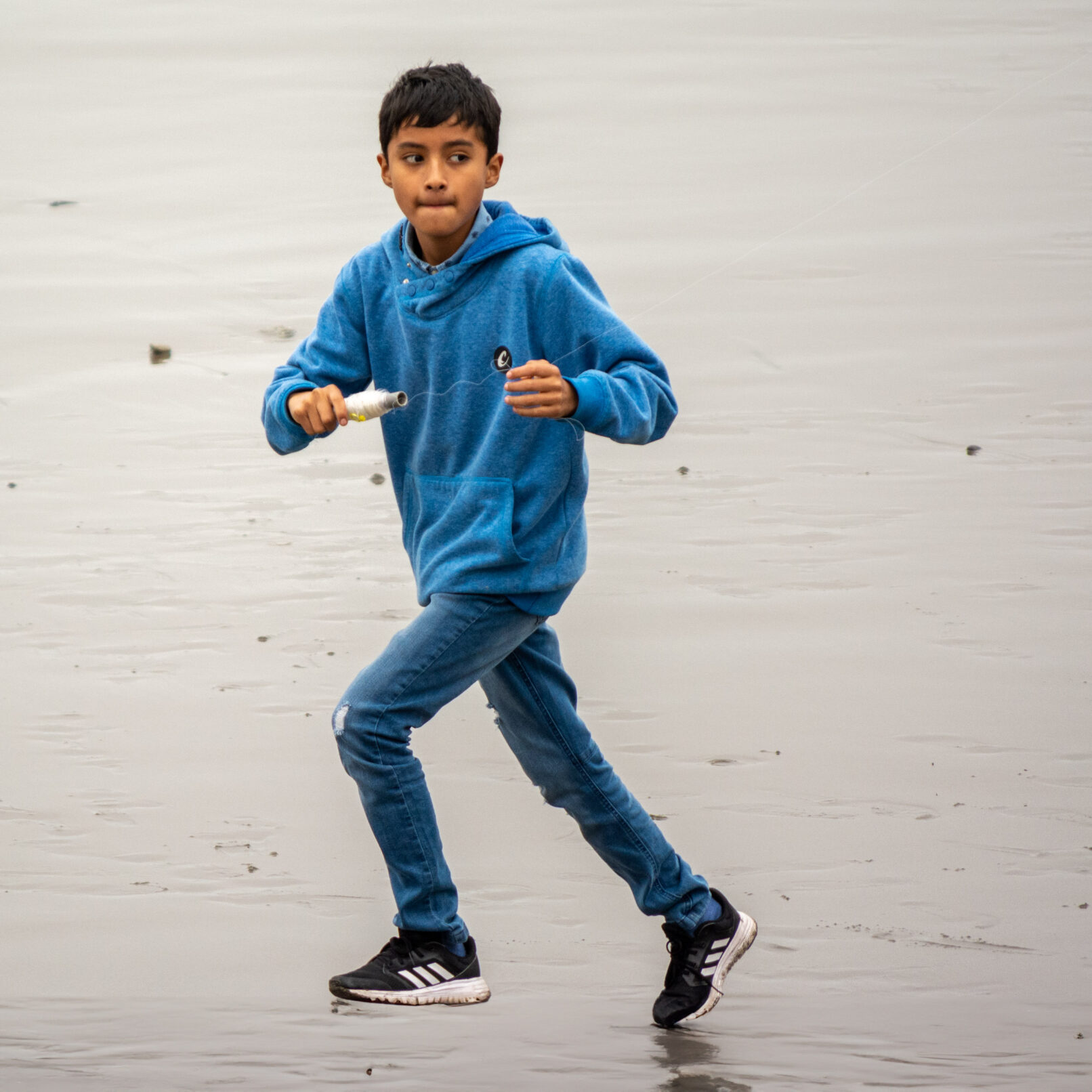 Peruvian boy flying kite