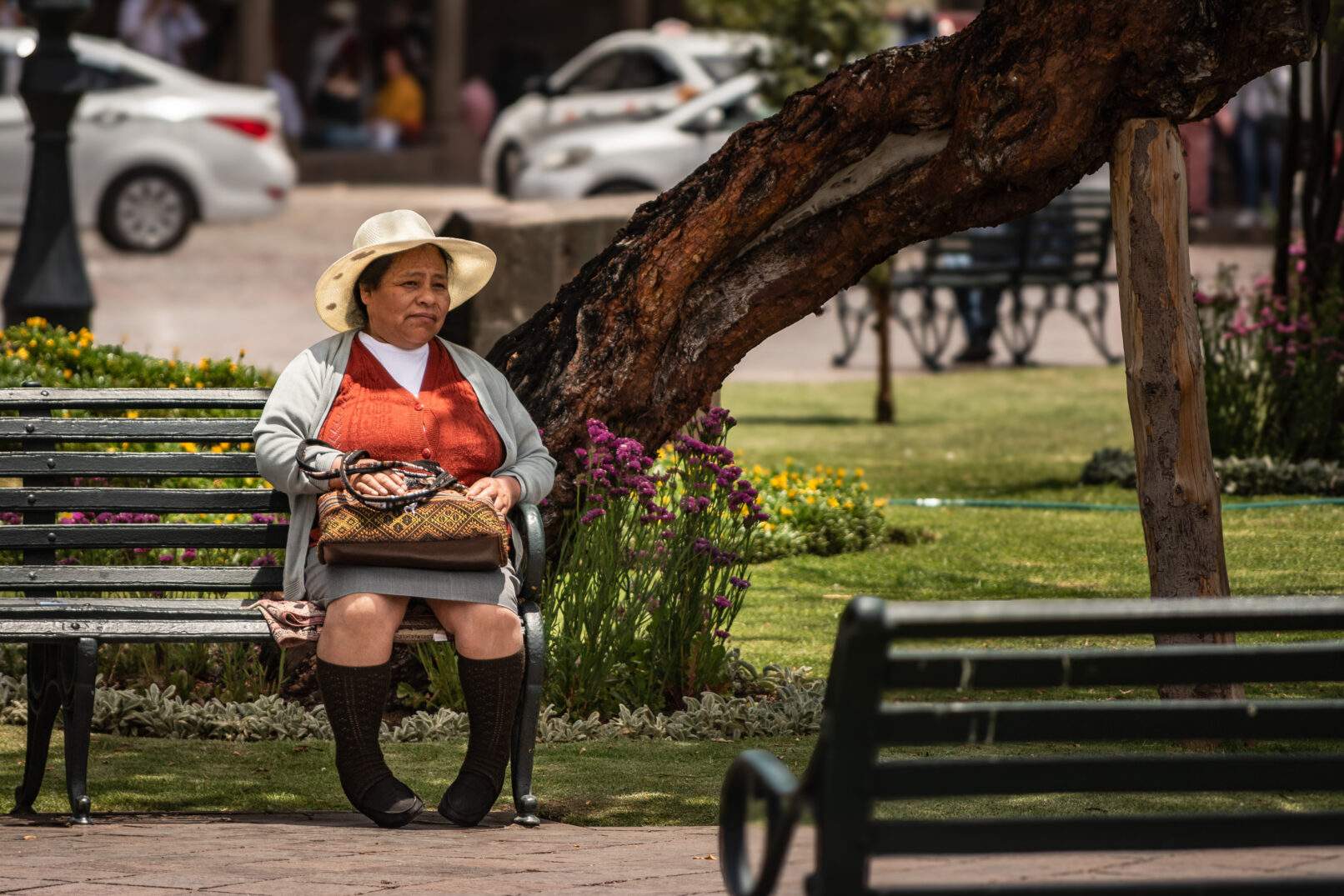 Peruvian woman sitting on bench